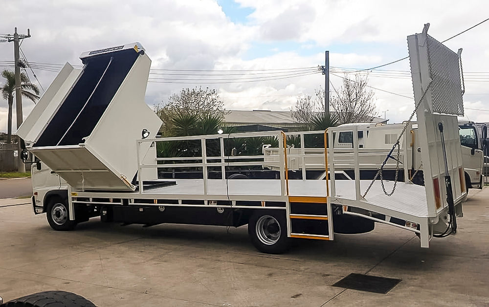 Hino custom beavertail truck body with integrated side tipper, access steps and rear loading ramp for council street sweeping operations, built by Metro Truck Body Builders in Seaford, Melbourne.