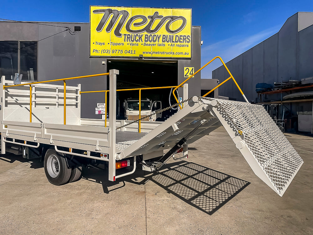 Council mower beavertail truck body with four-piece bi-fold mesh loading ramp and safety rails, custom built by Metro Truck Body Builders in Seaford, Melbourne.