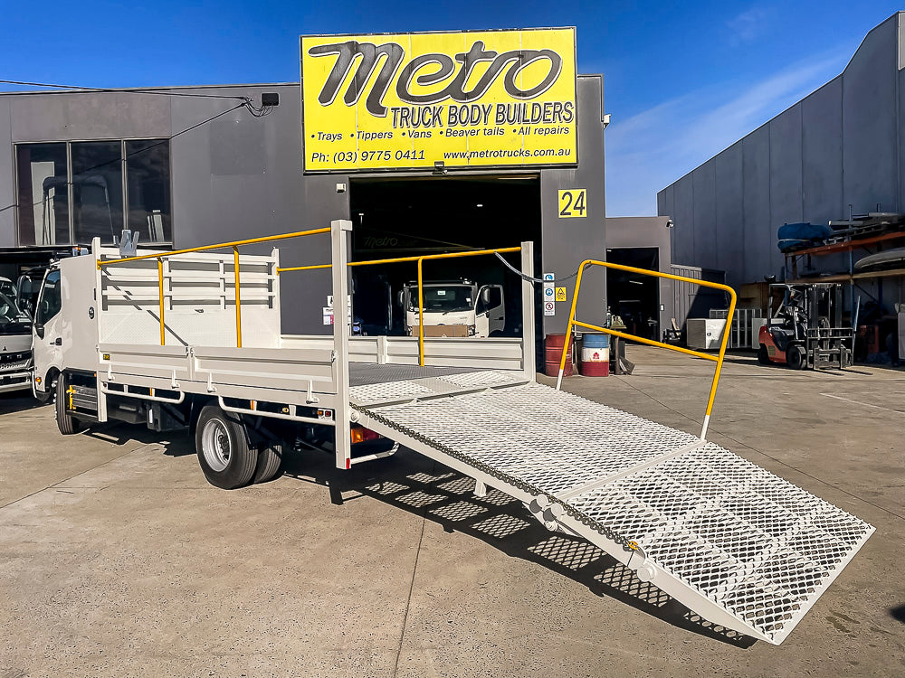 Custom beavertail truck body with loading ramp built by Metro Truck Body Builders, custom truck body builders and manufacturers in Seaford, Melbourne, Victoria.