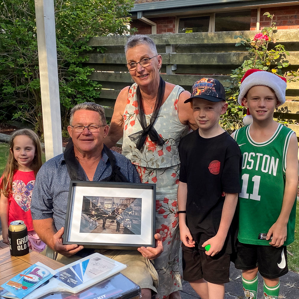 Doug receiving the framed Metro family workshop photo at Christmas in 2019