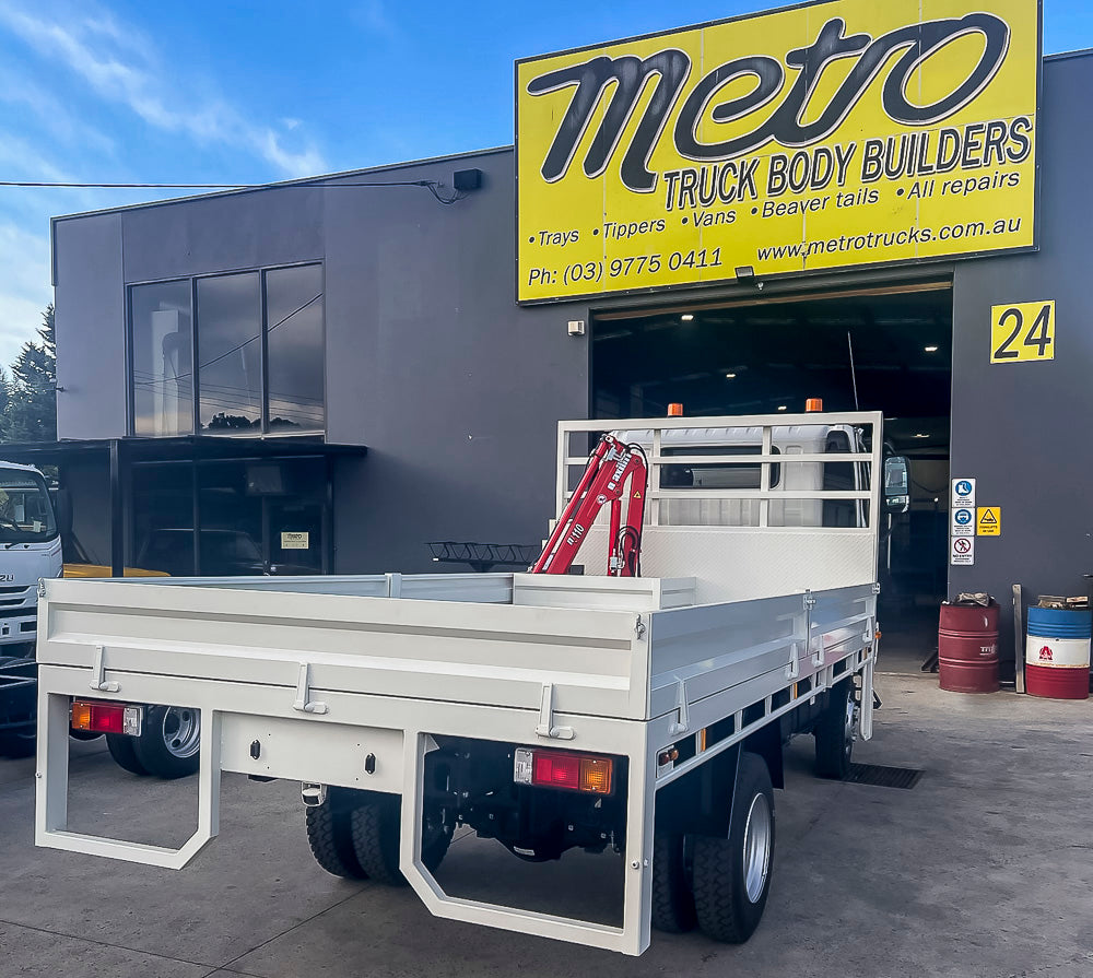 Custom split drop side truck tray with Maxilift ML110 crane, stabiliser leg and LED beacons built by Metro Truck Body Builders.