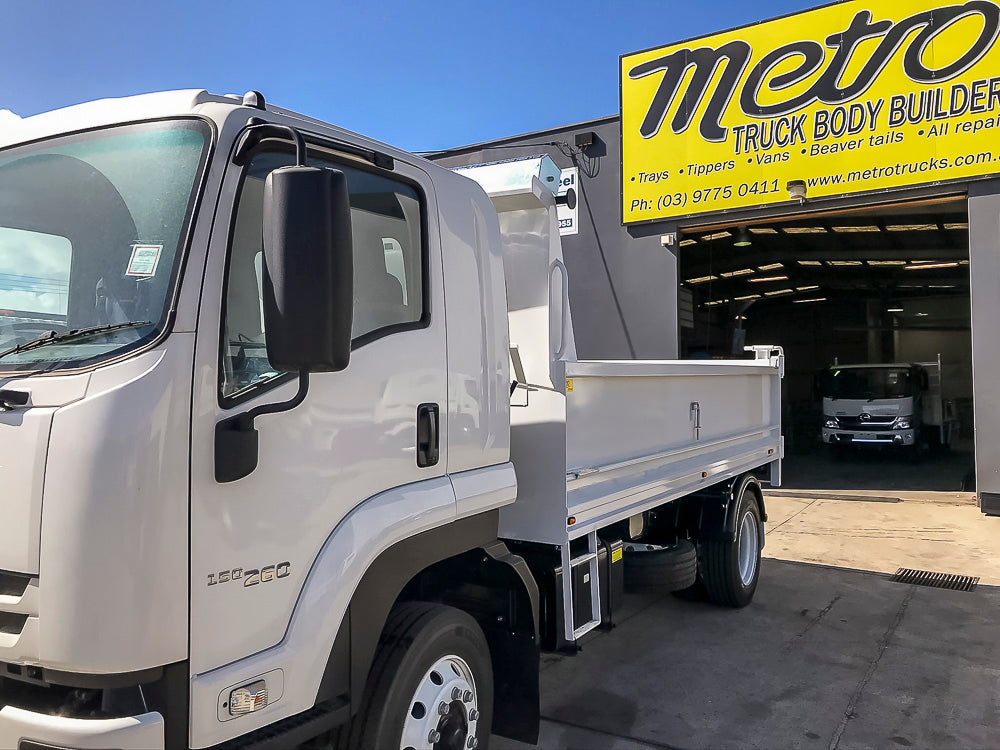 Custom truck tipper body with retractable mesh tarp, side steps and two-way tailgate by Metro Truck Body Builders