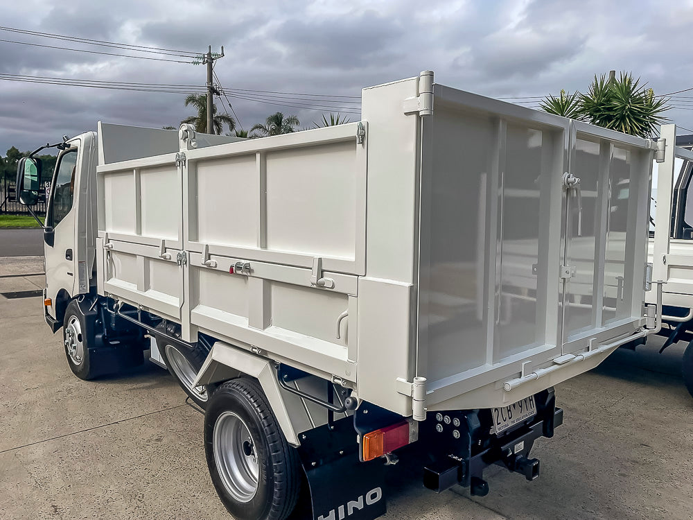 Custom split load tipper truck body with barn doors and hinged hungry boards built by Metro Truck Body Builders.