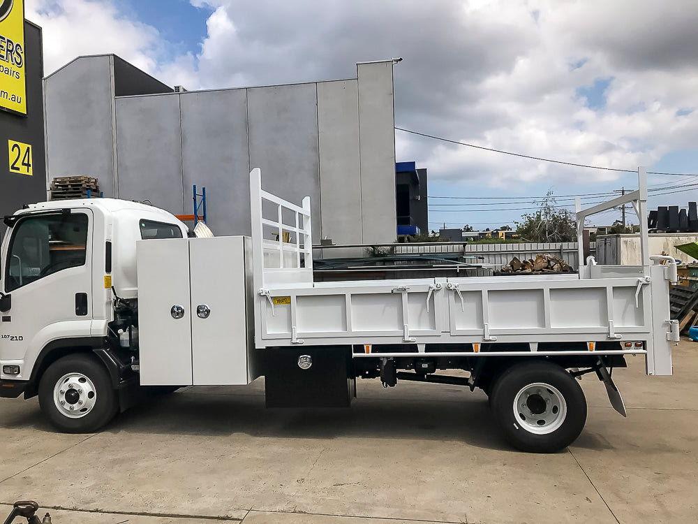 Custom split drop side tipper body with two-way tailgate, ladder rack and cabin-mounted toolbox built by Metro Truck Body Builders.
