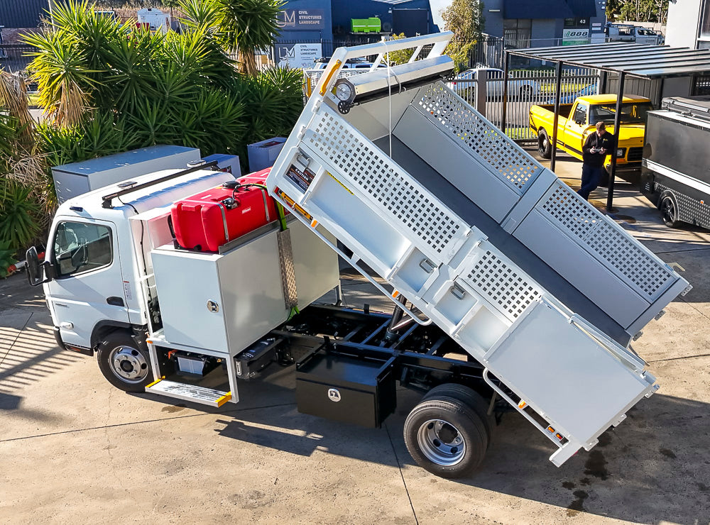 Custom split drop side tipper body with Fassi crane, retractable mesh tarp and toolbox built by Metro Truck Body Builders in Melbourne.