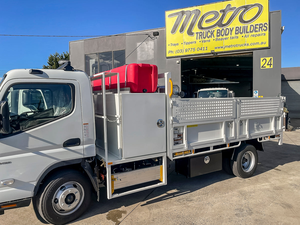 Custom tipper truck with behind-cab toolbox,sign rack, underbody toolbox and two 200L water tanks, built by Metro TruckBody Builders Melbourne.