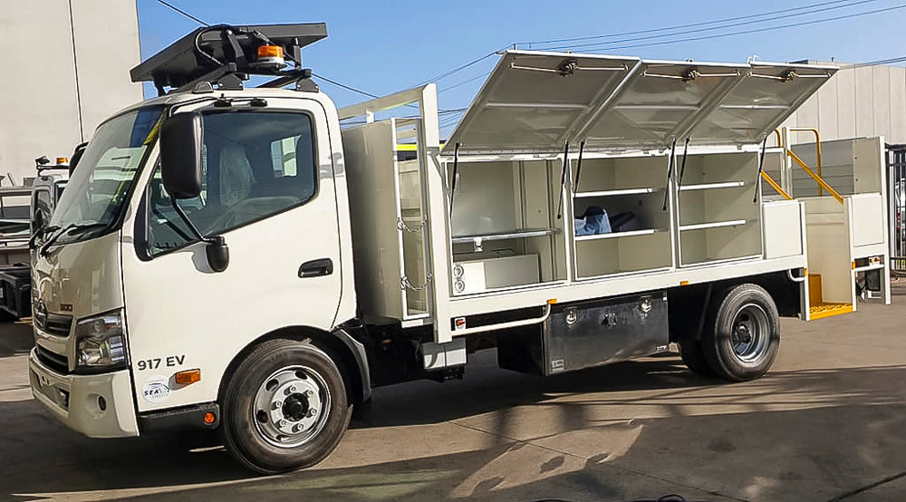 Custom service truck tray with side-mounted toolboxes, side step well, tailgate and cab-mounted arrow board, built by Metro Truck Body Builders Melbourne.
