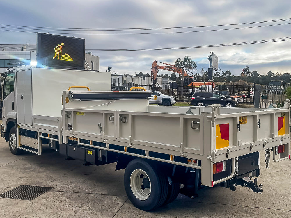 Custom council tipper truck with front tray, toolbox, VMS board and drop sides, built by Metro Truck Body Builders Melbourne.