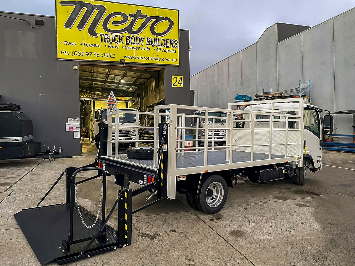 Custom gas bottle delivery truck body with bottle racking and rear hydraulic Tommy Gate, built by Metro Truck Body Builders Melbourne.